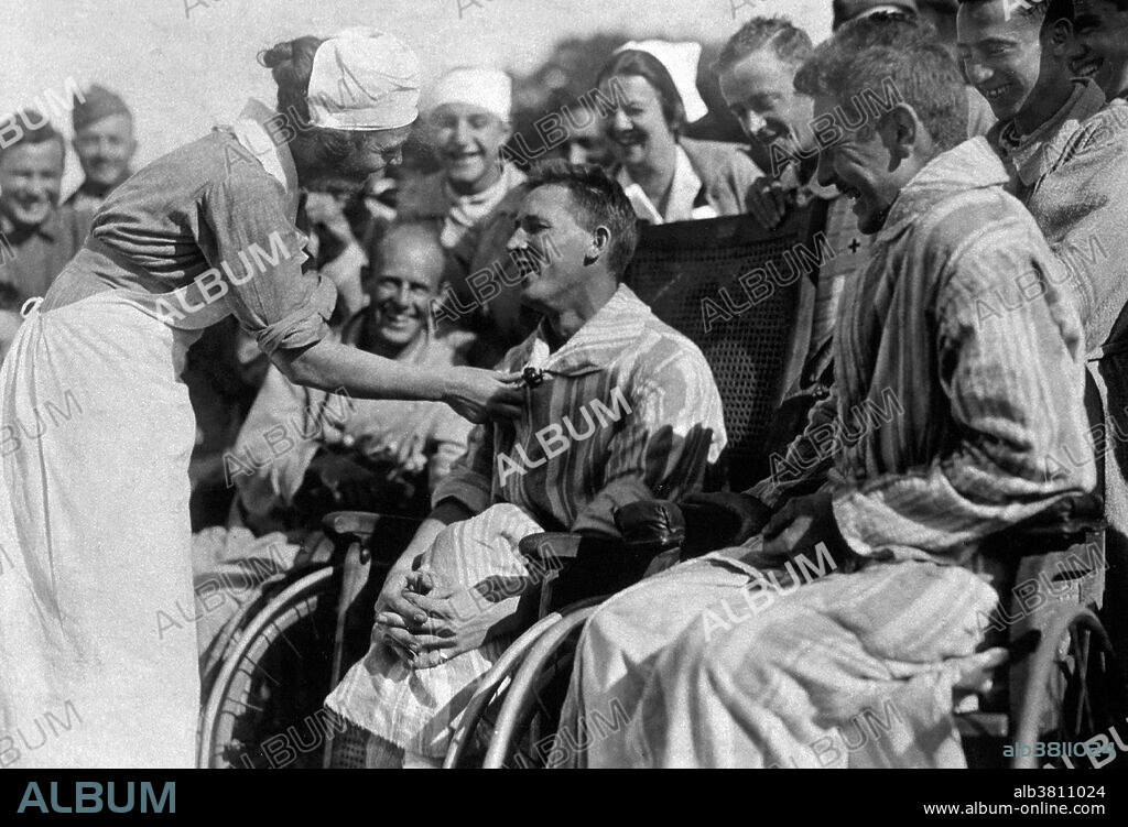U.S. American Red Cross Hospital No.5, Paris, France. Wounded soldiers with nurse at the Tent Hospital at Auteuil Race Track. The most important volunteer group in America during WWI was the American Red Cross. During WWI more than eighteen thousand Red Cross nurses served with the Army and Navy Nurse Corps. Some of these nurses worked at American base hospitals, at field units, and aboard ships, whereas others, served at home combating the 1918 influenza epidemic and providing medical services to military camps, munitions plants, and shipyards. They also helped to recruit and train ambulance drivers and orderlies at various universities. By the time the war ended in November 1918, the Red Cross had become a major national humanitarian organization.