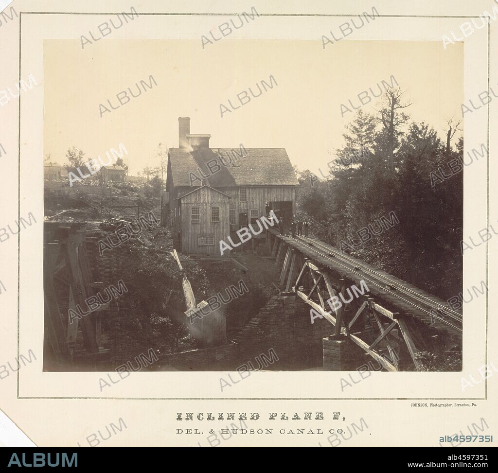 Inclined Plane F, Delaware and Hudson Canal Co., c. 1860. This engaging industrial scene is from a small, rare group of large-format photographs taken in the eastern United States during the Civil War era. Thomas H. Johnson operated a studio in Scranton, Pennsylvania, from 1861 until at least 1865. He made a series of images documenting the Delaware & Hudson Canal and Gravity Railroad operations--- primarily views of the Gravity Railroad's route through northeastern Pennsylvania.  For this image, one of only a few the photographer made of inclined tracks, company employees stood on the railroad ties while Johnson set up his camera, coated, and then exposed his large glass negative in the early morning light. Seen from afar, the unidentified men provide a sense of scale for the large building and the expansive landscape in which the facility was located.