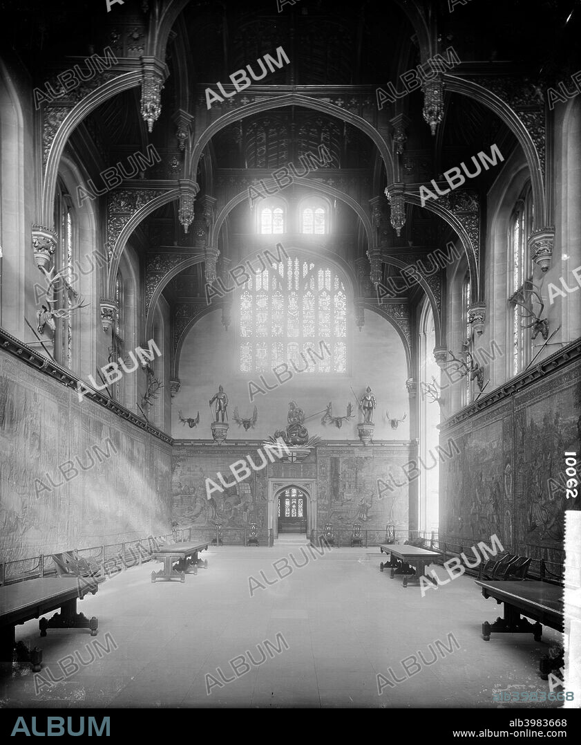 Great Hall at Hampton Court Palace, Richmond upon Thames, London, 1890, built for Henry VIII in 1523-24 to replace Cardinal Wolsey's hall. The tapestries are of a similar period. The painted hammerbeam roof has ornately carved pendants. Above the tapestries, the walls are lined with stags' heads.