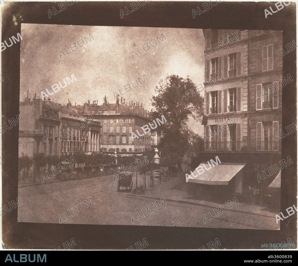 The Boulevards at Paris. Artist: William Henry Fox Talbot (British, Dorset 1800-1877 Lacock). Dimensions: 15.1 x 19.9 cm (5 15/16 x 7 13/16 in. ). Date: May-June 1843.
Talbot traveled to Paris in May 1843 to negotiate a licensing agreement for the French rights to his patented calotype process and, with Henneman, to give firsthand instruction in its use to the licensee, the Marquis of Bassano.
No doubt excited to be traveling on the continent with a photographic camera for the first time, Talbot seized upon the chance to fulfill the fantasy he had first imagined on the shores of Lake Como ten years before. Although his business arrangements ultimately yielded no gain, Talbot's views of the elegant new boulevards of the French capital are highly successful, a lively balance to the studied pictures made at Lacock Abbey. Filled with the incidental details of urban life, architectural ornamentation, and the play of spring light, this photograph, unlike much of the earlier work, is not a demonstration piece but rather a picture of the real world. The animated roofline punctuated with chimney pots, the deep shopfront awning, the line of waiting horse and carriages, the postered kiosks, and the characteristically French shuttered windows all evoke as vivid a notion of mid-nineteenth-century Paris now as they must have when Talbot first showed the photographs to his friends and family in England.
A variant of this scene, taken from a higher floor in Talbot's Paris hotel, appeared as plate 2 in "The Pencil of Nature.".