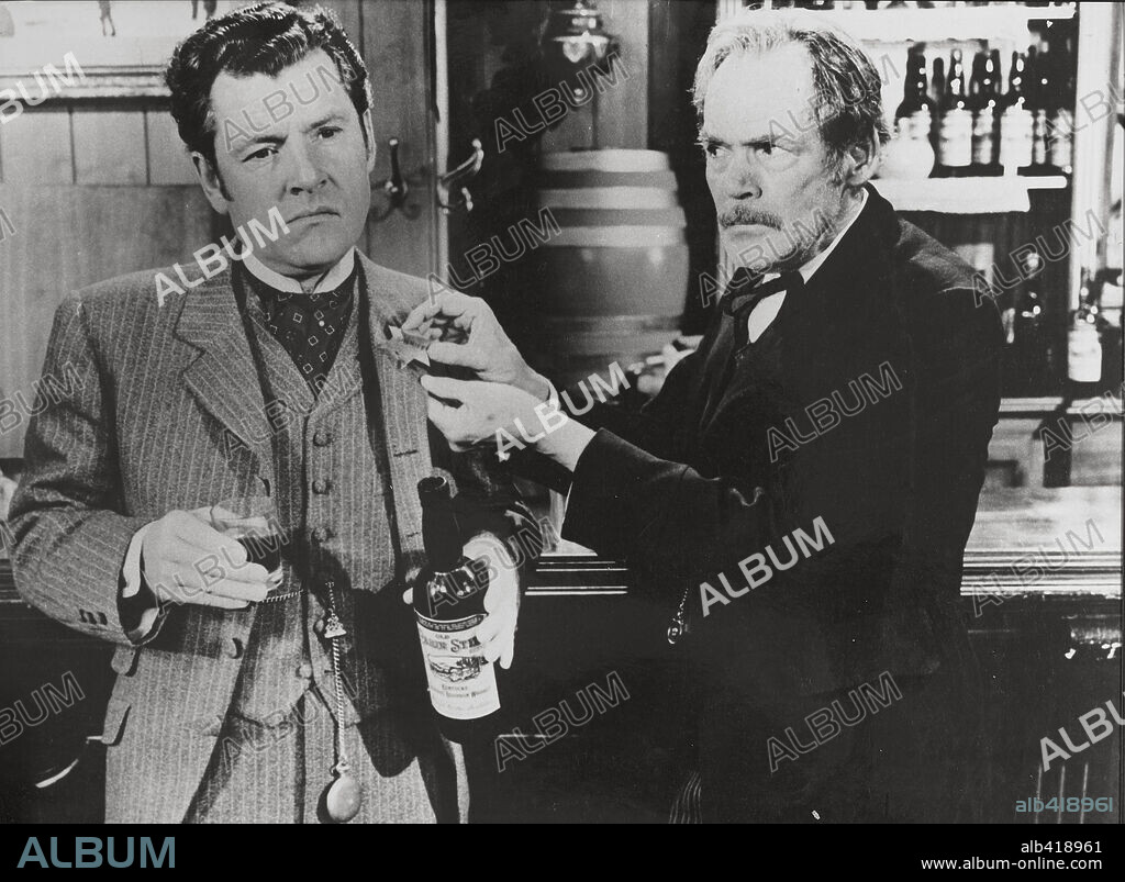 KENNETH MORE in THE SHERIFF OF FRACTURED JAW, 1958, directed by RAOUL WALSH. Copyright 20TH CENTURY FOX.