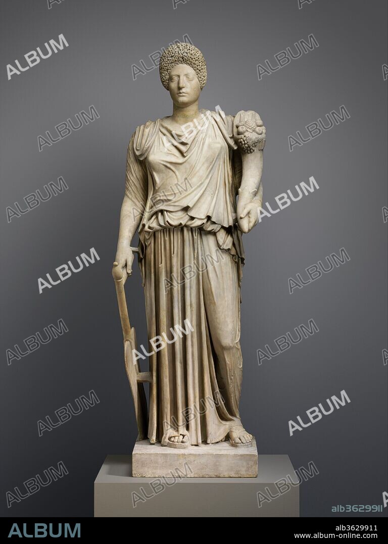 Marble statue of Tyche-Fortuna restored with the portrait head of a woman. Culture: Roman. Dimensions: Other: 75 x 26 x 23 in. (190.5 x 66 x 58.4 cm). Date: 1st or 2nd century A.D..
Tyche wearing double chiton, holding cornucopia in left hand and steering paddle in right. Adaptation of Greek original.