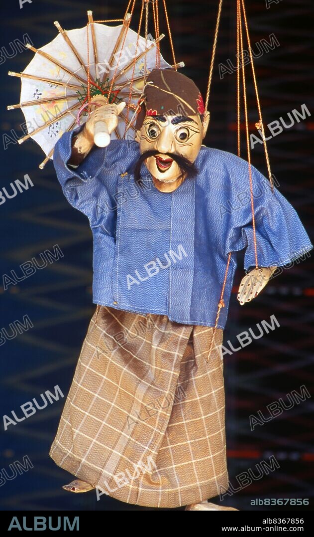 Burma / Myanmar: A traditional Burmese puppet (Yoke thé) on sale, Bogyoke Aung San Market, Yangon (Rangoon). Yoke thé (lit. miniatures) is the Burmese name for marionette puppetry. Although the term can be used for marionettery in general, its usage usually refers to the local form of string puppetry. Like most of Burmese refined art, Yoke thé performances originated from Royal patronage and were gradually adapted for the wider populace. Yoke thé are almost always performed in operas.
