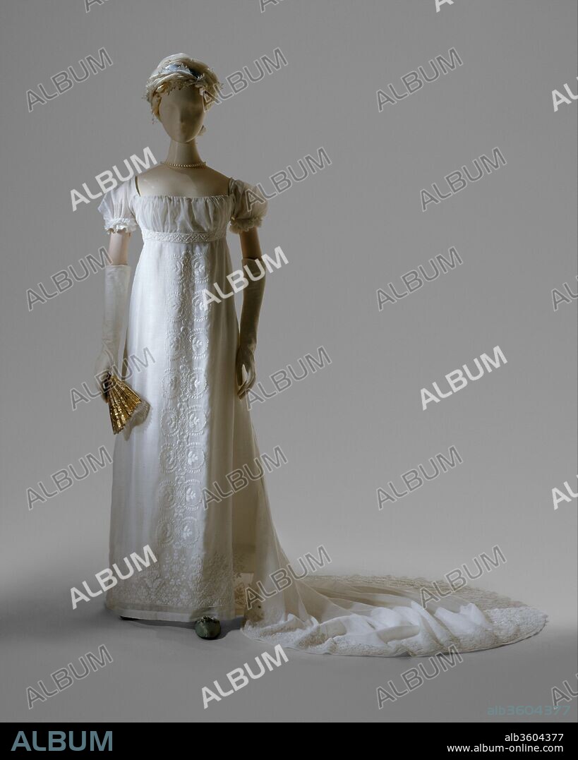 Evening dress. Culture: French. Date: 1804-5.
On December 24, 1803, Jerome Bonaparte (1784--1860), brother of Napoleon, wed Elizabeth Patterson (1785--1879) of Baltimore.  The beautiful and fashionable young American was married in a dress of muslin and lace that, according to a contemporary, "would fit easily into a gentleman's pocket."  This description evokes the sheer, narrow dresses that caused a sensation at the beginning of the nineteenth century, more because of their contrast with the elaborate hooped costumes of previous decades than for any real immodesty.  
Although originally thought to have been Patterson's wedding dress, the formal gown illustrated here probably dates from 1804, when this type of vertical white embroidery became fashionable.  The very sheer cotton mull from which the dress is made was probably imported from India already embroidered with heavy white cotton thread in transparent mull. Only a daring few had briefly abandoned these items of clothing, in imitation of "Grecian" drapery--the first of many fanciful nineteenth-century allusions to details of costume in earlier historic periods.
As for the Patterson-Bonaparte union: Napoleon had the marriage annulled in 1805 and made Jerome the king of Westphalia in 1807.  That year, Jerome married the princess of Wurttemberg.  Elizabeth, banned from France by the emperor, remained in Baltimore with her son, Jerome Napoleon Bonaparte (1805--1870).