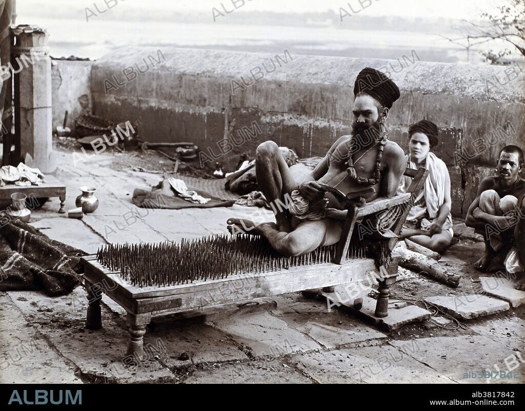 A fakir (here, a Hindu ascetic or wonder-worker) sitting on a bed of nails in Benares, India. Photograph by R. C. Mazumdar, c. 1900.