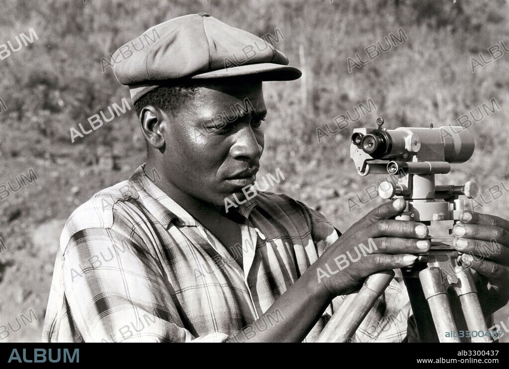 Swaziland:  March, 1964.A Swazi engineer setting a level on a transit during construction of the new cross country highway being built and financed by the World Bank.
