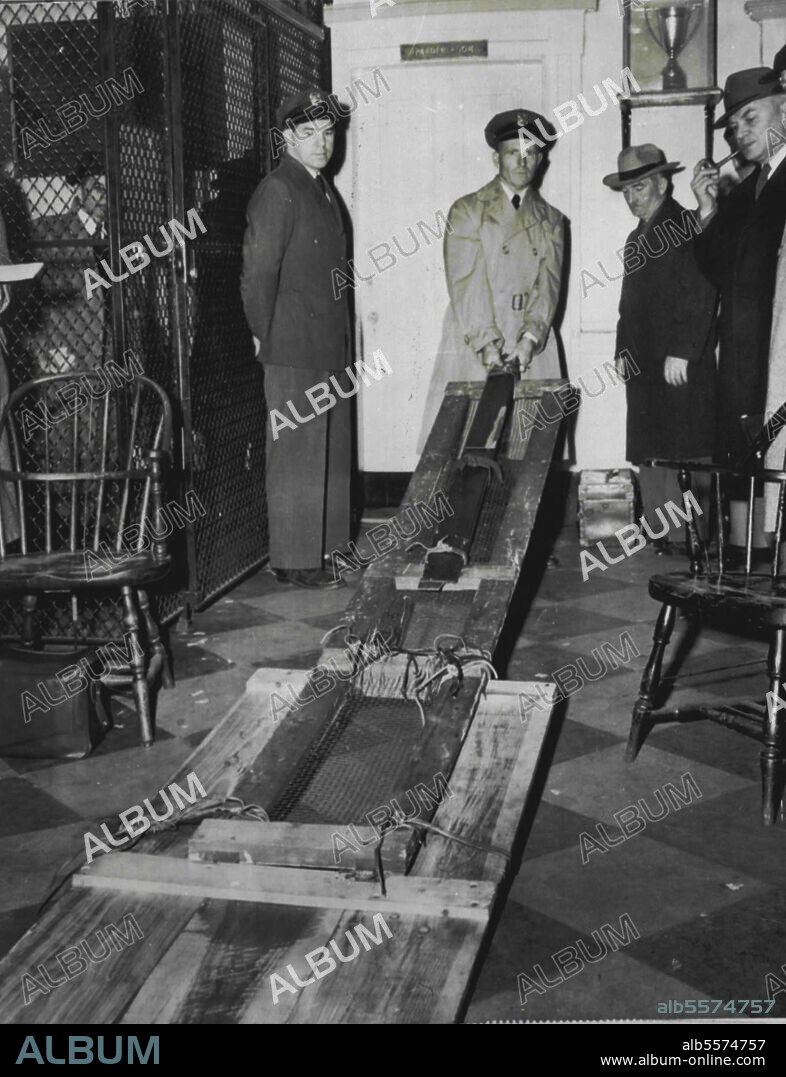 Ladder Found During Prison Riot -- State Prison guard John Lavery holds a crude ladder found in yard of prison today in search after rioters held five guards hostage in a breakout attempt. Four hardened inmates of the solitary confinement cellblock are still holding guards. January 18, 1955. (Photo by AP Wirephoto).