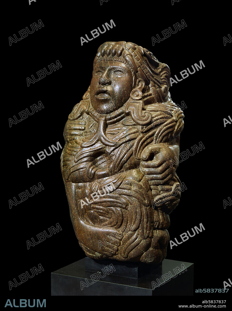 Statue of the God Quetzalcoatl. His name signifies the " feathered serpent". The god's head emerges from the mouth of the serpent; his earrings with a hook show that he is the god of the winds. Stone, H: 44 cm Depot du Musee de l'Homme Inv. M. H. 78.1.59.