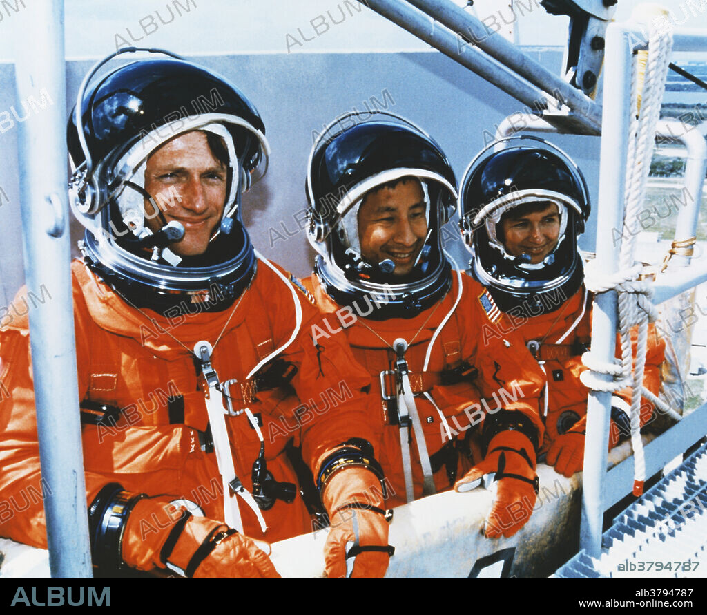 Astronauts Michael Foale, (l), Edward Lu, (center), and cosmonaut Yelena Kondakova, (r), training on a launch pad at Kennedy Space Center, Florida. This was during a Terminal Countdown Demonstration Test, ie a launch rehearsal. Here they are practicing emergency escape procedures. Foale was preparing for a stay as the guest researcher aboard Mir. Foale joined the Mir group during mission STS-84, and staying until he was picked up by mission ST-86, (September-October 1997).