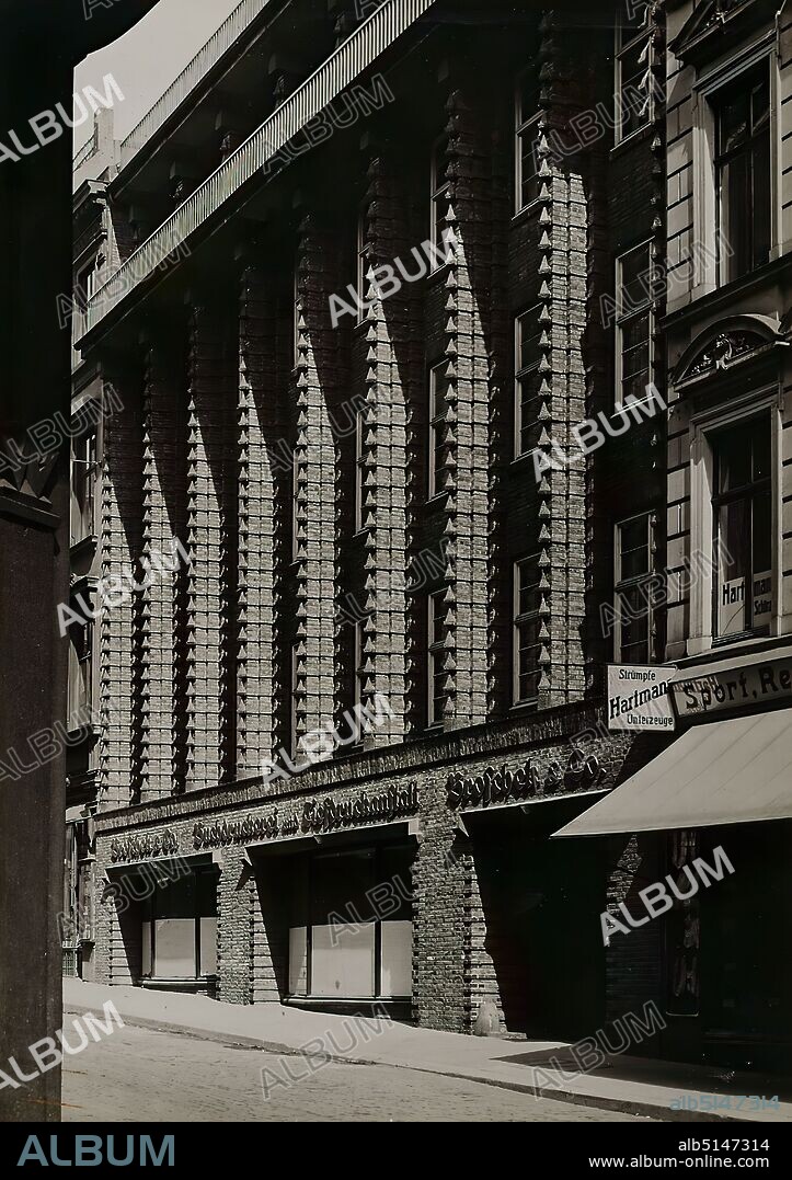 Photographenatelier Gebr. Dransfeld, Carl Dransfeld, Broschekhaus, Verlagshaus der Tageszeitung Hamburger Fremdenblatt, Hamburg-Neustadt, silver gelatine paper, black and white positive process, image size: height: 22,30 cm; width: 15,70 cm, inscribed: recto on the cardboard: in ink, top: Photo: Dransfeld, Hamburg 39; bottom: photo of the photographer : Buchdruckerei Broschek Hamburg, Architect, D.W.B. Fritz Höger Hamburg, architectural photography, facade ,house, building, profane architecture, The photo studio Dransfeld Bros. was founded in 1902 by the trained lithographer Carl Dransfeld and his brother, the painter Adolf Dransfeld, in Berlin and moved to Hamburg in 1904. Building director Fritz Schumacher commissioned the Dransfeld brothers to document the public buildings he had constructed since 1909. This prestigious commission established the Dransfeld brothers as leading architectural photographers in 1920s Hamburg. Among the architects for whom the studio worked were Fritz Höger, Martin Elsaesser, Distel & Grubitz or the Gerson brothers. With their photograph of the Chile House designed by Höger, Carl and Adolf Dransfeld created an icon of architectural photography. By creating a strong view from below and using a wide-angle lens, they reinforced the expressionist character of the building's top, thus contributing significantly to the popularity of modern Hamburg brick architecture. The Broschekhaus was built as an office and commercial building in 1925/26 in Hamburg's Neustadt district, also according to Höger's plans. The building was the premises of the publishing house Broschek & Co, which also published the Hamburger Fremdenblatt, and is now used as a hotel. (Sven Schumacher).