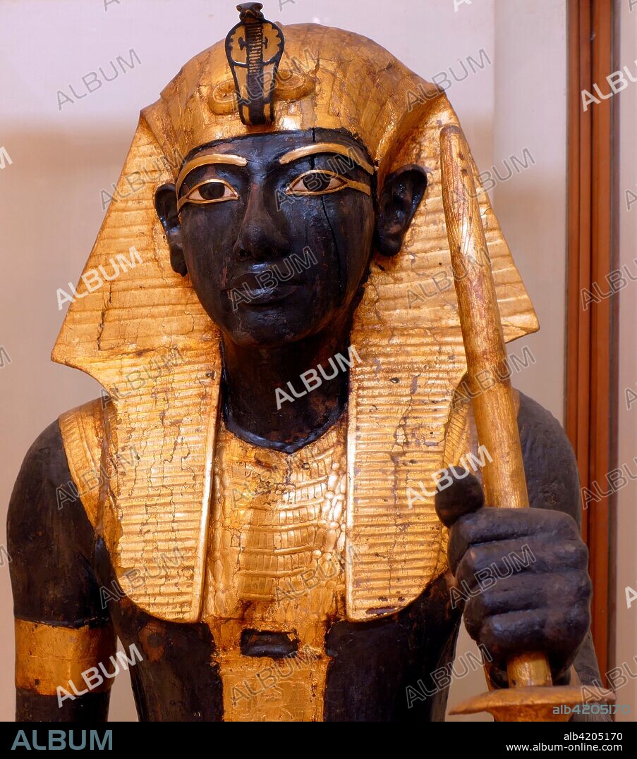 gilded wooden guardian statues from King Tutankhamen's burial chamber. Tutankhamen was an Egyptian pharaoh of the 18th dynasty (ruled c. 1332–1323 BC). during the period of Egyptian history known as the New Kingdom.
