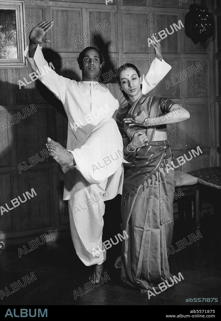 The Dance Of The Fingers -- His expressive fingers twitching, flicking snapping and writhing like snakes, Chathunni Panicker performs a Kathakali dance. Watching him are Leela Bhaskaraya and Mrinalini Sarabhai, two of the leading dancers in an Indian troupe who ***** in London last night. May 30, 1951. (Photo by Daily Mirror).