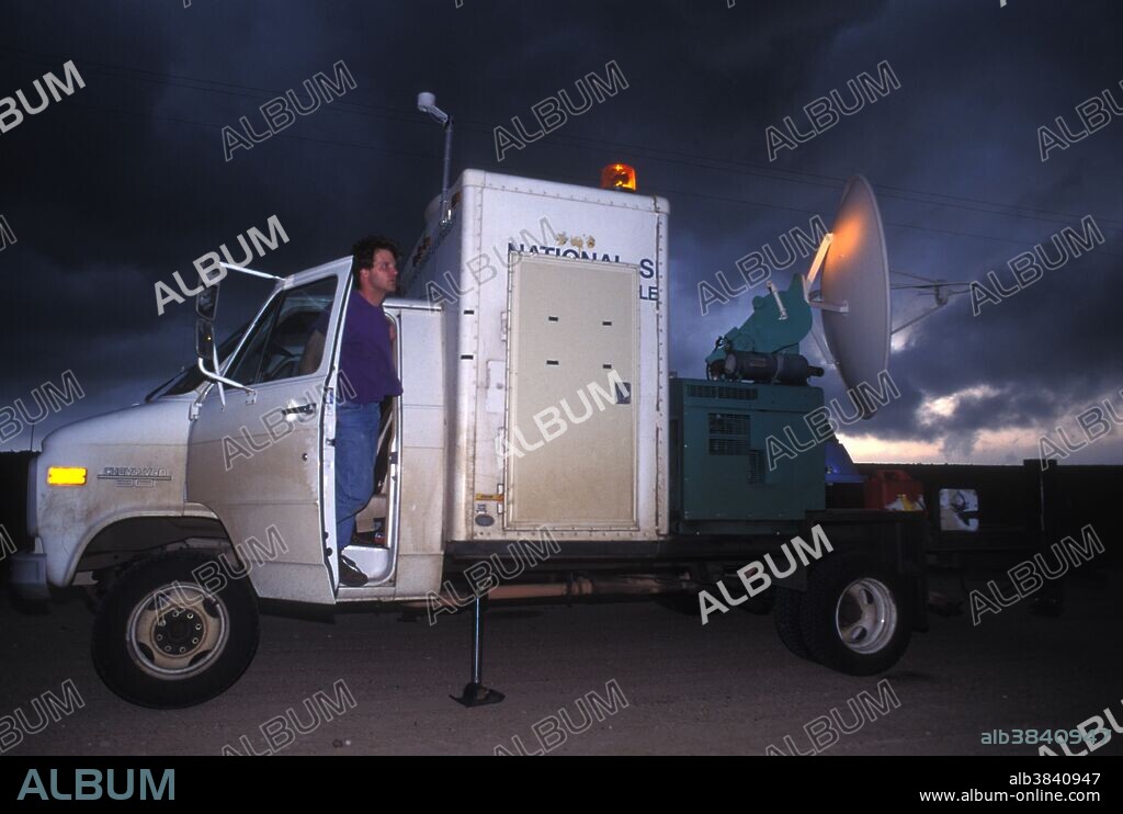 Tornado researcher Jerry Straka studies the sky from the very first Doppler on Wheels portable weather radar truck (DOW I). Oklahoma, USA.