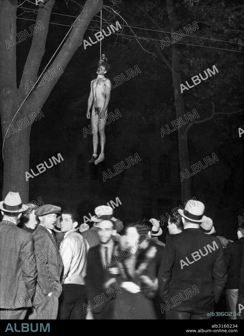 San Jose, California: November 27, 1933 The body of John Holmes, alleged kidnaper and slayer of Brooke Hart, shown after a mob which dragged him from the county jail, completed its work. He was beaten and hanged from a tree in St. James city park, 100 yards from the jail. Thomas Thurmond, his alleged accomplice, was strung up a few minutes earlier.