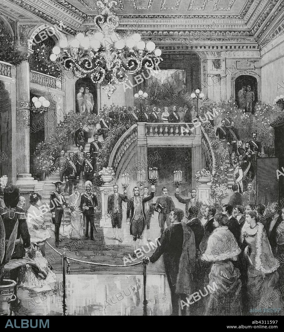 Bélgica. Bruselas. Viaje de S. M. el rey Alfonso XII (1857-1885). El vestíbulo del "Theatre Royal de la Monnaie" (Teatro Real de la Moneda), en el acto de salir SS. MM. de la función de gala celebrada el 28 de septiembre de 1883. Dibujo del natural por Juan Comba. Grabado por Rico. La Ilustración Española y Americana, 30 de octubre de 1883.