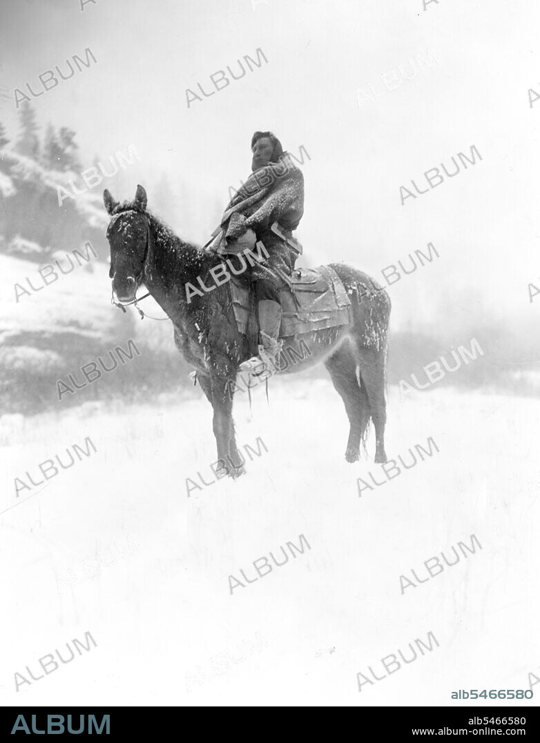 Edward S. Curtis Native American Indians -Apsaroke man on horseback on snow-covered ground, probably in Pryor Mountains, Montana circa 1908.