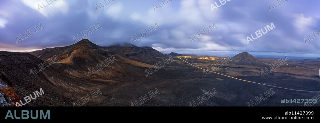 Dusk over the majestic Tindaya mountain and village in the desert landscape, La Oliva, Fuerteventura, Canary Islands, Spain, Atlantic, Europe.