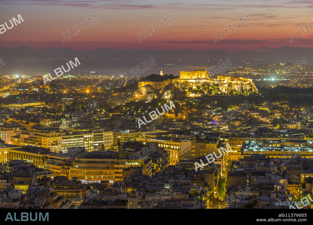 View of Athens and The Acropolis from Likavitos Hill with the Aegean Sea visible on horizon at dusk, Athens, Greece, Europe.