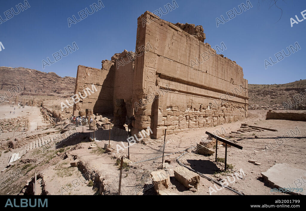 Built of sandstone blocks, this temple was the most important temple in the city of Petra, probably dedicated to the Nabataean god Dushrat (Dushares). A flight of 22 white marble steps leads to a recessed portico with four columns. The portico then opens into the main chamber of the table, in the opposite wall of which are three openings. The central opening is topped by an arch. Both the internal and external walls were covered with plaster. On the east facade the relief stucco work forms a frieze of pilasters further decorated with bas-relief panels. The temple is popularly known by its Bedouin name as the Qasr al-Bint Firaun ("The Palace of Pharaoh's Daughter"). The Nabataean city of Petra in Jordan was declared a World Heritage Site by UNESCO in 1985.