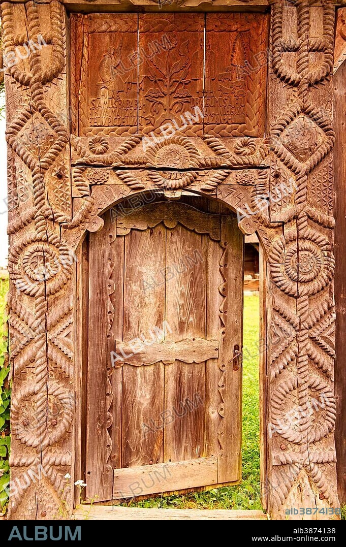 19th century traditional Iza Valley farm house carved wooden folk art gates, Village Museum, near Sighet, Maramures, northern Transylvania, Romania, Europe.