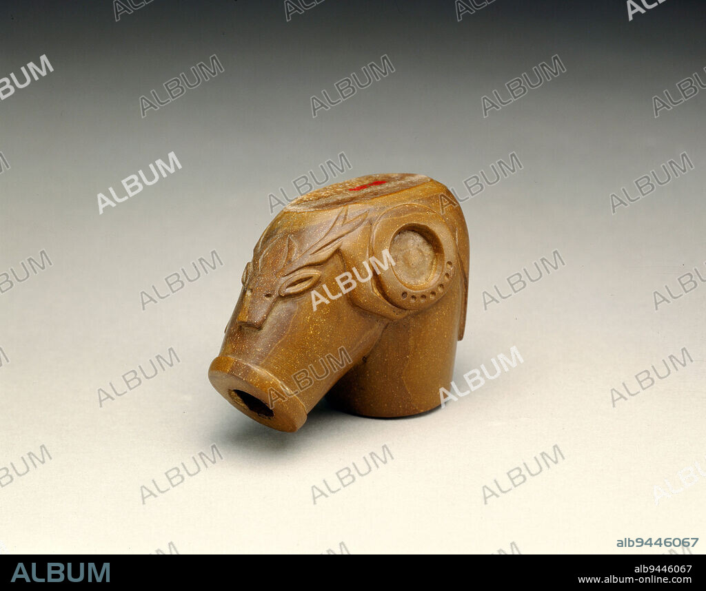 Pipe Bowl, c. 1860, 2 1/4 x 1 3/8 x 2 15/16 in. (5.7 x 3.5 x 7.5 cm), Stone, United States, 19th century, The image of a bull elk with his outstrectched neck and antlers low on his shoulders is carved in shallow relief on the underside of this elbow-shaped pipe bowl. The circle or hoop near the animal's foreleg may associate this pipe bowl with the Elk Dreamer's Society. This pipe is displayed upside down.