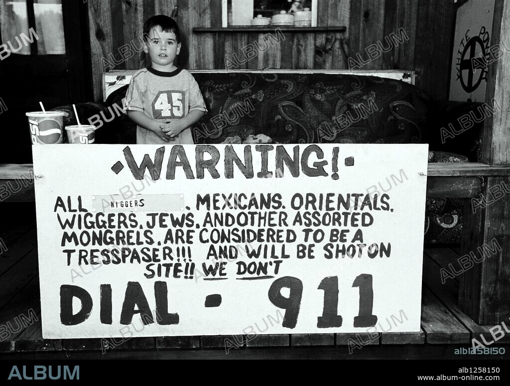 Aug 10, 2002; Petal, MS, USA; Jeran Cook, 4, grandson of South Mississippi Knights of the Ku Klux Klan Imperial Wizard Jimmie Maxey, stands on the porch of Maxey's home during a memorial rally on August 10, 2002, in Petal, Mississippi, following Maxey's death. Mandatory Credit: Photo by James Edward Bates/Baptist Press/ZUMA Press. (©) Copyright 2002 by James Edward Bates/Baptist Press. 10/08/2002