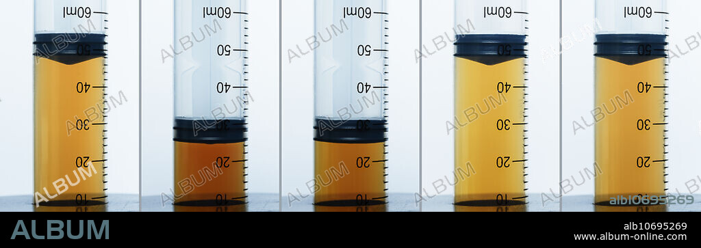 Nitrogen dioxide equilibrium. Nitrogen dioxide (NO2) gas exists in equilibrium with dinitrogen tetroxide (N2O4) gas, 2NO2 <-> N2O4. NO2 is a brown gas, while N2O4 is colourless. This series demonstrates the effect of pressure on the NO2 <-> N2O4 equilibrium. A gas syringe is filled with a mixture of the two gases (frame 1). When the plunger is rapidly pushed in to decrease the gas volume by half, the colour darkens due to increased concentration of NO2 (frame 2). However, within seconds the colour lightens slightly as the equilibrium shifts and some NO2 is converted to N2O4 (frame 3), in accordance with Le Chatelier's principle. When the plunger is released, the changes are reversed: the mixture first lightens noticeably (frame 4), and then darkens slightly (frame 5).