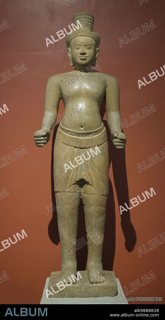 Cambodia: A 9th century Preah Ko style sandstone statue of the Hindu god Shiva, originally from Angkor, now in the National Museum of Cambodia, Phnom Penh. The National Museum, housed in a red pavilion built in 1918, holds a collection of Khmer art including some of the finest pieces in existence. Exhibits include a 6th century statue of Vishnu, a 9th century statue of Shiva, and the famous sculpted head of Jayavarman VII in meditative pose. Particularly impressive is a damaged bust of a reclining Vishnu which was once part of a massive bronze statue found at the Western Mebon Temple in Angkor.