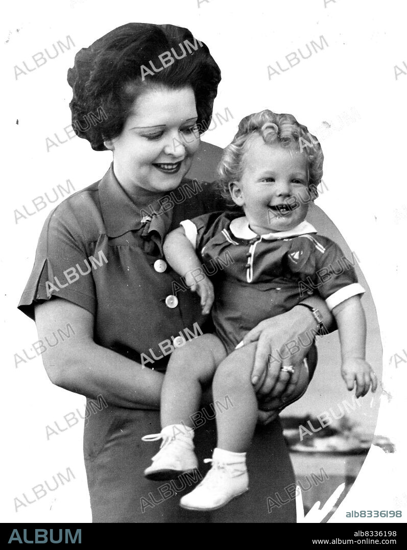 Clara Bow And Her Son - ***** Belden, 11-moths-old son of Clara Bow and ***** film players, is show in one of first ***** with his famed mother, taken when the family ***** at this desert resort. Belden is Bell's family name. ***** Larbow is a combination of the actress two names. December 18, 1935. (Photo by Associated Press Photo).
