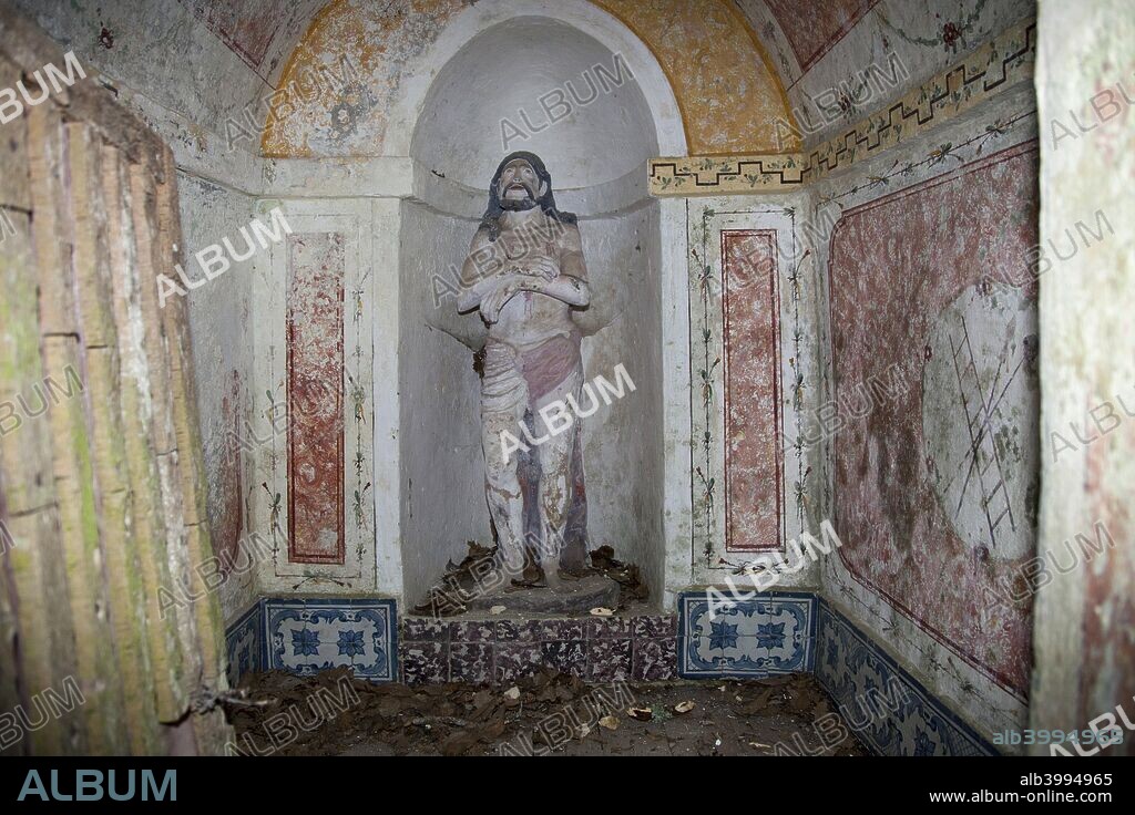 Statue of the Christ, Capuchos Convent, Sintra, Portugal, 2009. Founded in 1560 by the son of the governor of India, this convent is located on a hilltop and was carved by hand out of a huge granite rock. It is also known as the Cork Convent because the tiny cells are lined with cork. The monks lived here up until 1834 when it was abandoned.