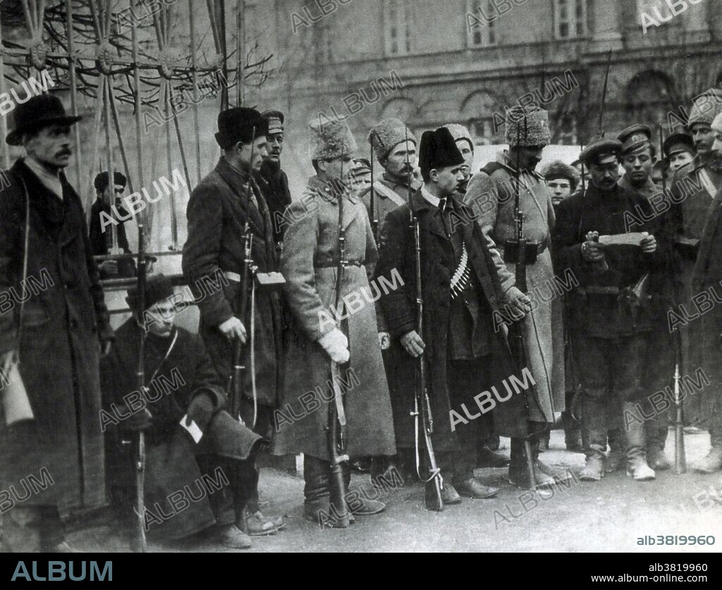 Red Guards and Delegates in the October Revolution. Red Guards were paramilitary volunteer formations consisting mainly of factory workers, peasants, cossacks and partially of soldiers and sailors for "protection of the Soviet power". Red Guards were a transitional military force of the collapsing Imperial Russian Army and the base formations of Bolsheviks during the October Revolution and the first months of the Civil War. Most of them were formed in the time frame of the Russian Revolution of 1917 and some of the units were reorganized into the Red Army during 1918. The October Revolution was a seizure of state power instrumental in the larger Russian Revolution of 1917. It took place with an armed insurrection in Petrograd traditionally dated to October 25, 1917 (by the Julian or Old Style calendar, which corresponds to November 7, 1917 in the Gregorian or New Style calendar). Bolshevik Red Guards forces under the Military Revolutionary Committee began the takeover of government buildings on October 24, 1917 (O.S.). The October Revolution in Petrograd overthrew the provisional government and gave the power to the local soviets. No photographer credited, dated 1917.