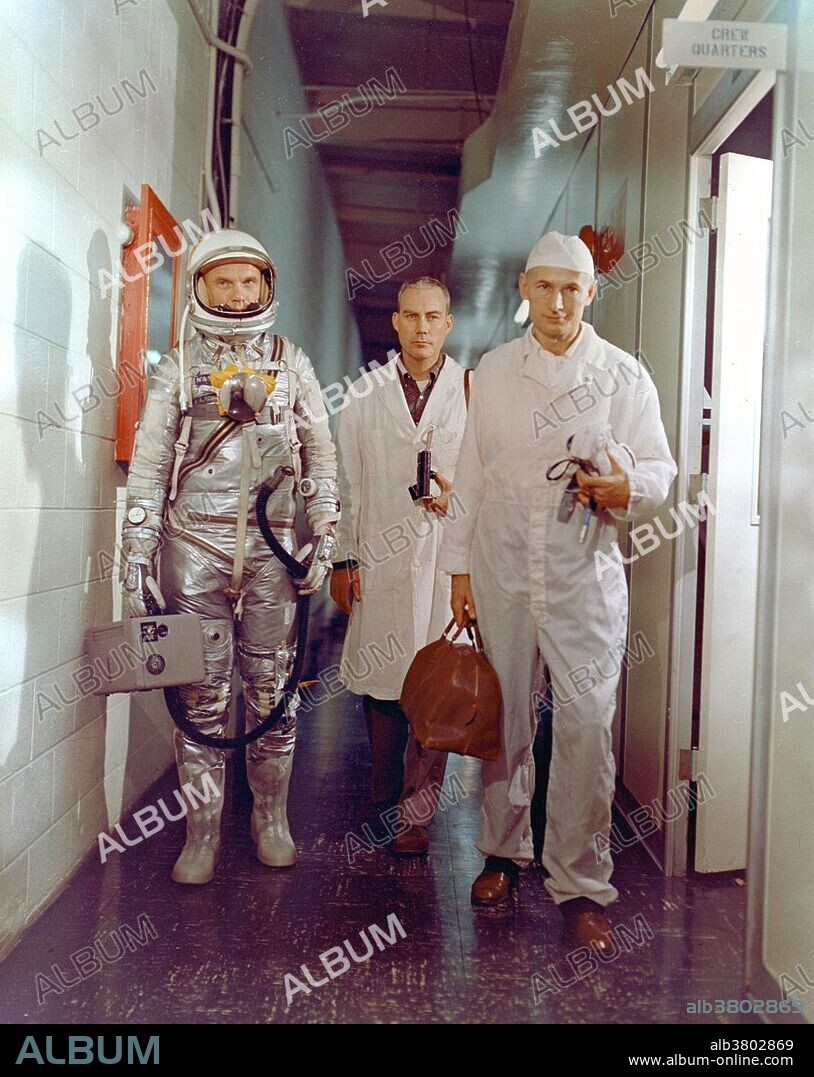Astronaut Glenn, NASA flight surgeon William Douglas and equipment specialist Joseph W. Schmidt leave crew quarters prior to mission. Glenn is in his pressure suit and is carrying the portable ventilation unit. Mercury-Atlas 6 (MA-6) was the third human spaceflight for the US and part of Project Mercury. Conducted by NASA on February 20, 1962, the mission was piloted by astronaut John Glenn, who performed three orbits of the Earth, making him the first US astronaut to orbit the Earth. The Mercury spacecraft, named Friendship 7, was carried to orbit by an Atlas LV-3B launch vehicle lifting off from Launch Complex 14 at Cape Canaveral, Florida. After four hours and 56 minutes in flight the spacecraft re-entered the Earth's atmosphere, splashed down in the Atlantic Ocean and was safely taken aboard the USS Noa.