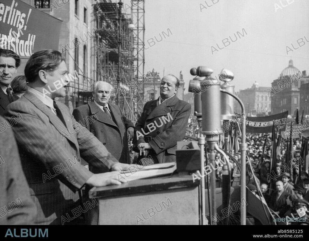 Orig. bildtext... WESTERN POWERS DENOUNCED AT EAST BERLIN PROTEST MEETING AGAINST CURRENCY BAN 28-3-49 100,000 East Berliners gathered on Unter den Linden before the Berlin University in a protest meeting against the banning of the East Mark in the Western Sectors. The meeting, efficiently organised by the SED (Communist Party) was marked by quiet and lack of spirit. Principal speaker, Hans Jendretzki, head of Berlin SED described the currency reform as a piece of political provocation and another example of Western war-mongering all over the world. Photo shows: Hans Jendretzki during his speach at the currency reform protest meeting in which he denounced the Western Powers. Orig. bildtext... 29 MARCH 1949 A few days ago a big mass demonstration by Berlin communists took place in front of the university Unter den Linden in Berlin during which uniform currency as well as uniform supply of vital goods for Berlin was demanded. Speaker of the demonstration was Hans Jendretzky, chairman of the Berlin Social Unit Party. Pict. shows Hans Jendretzky during his speech. Beside him are Wilhelm Pieck and Friedrich Ebert. Anm. H Jendretzky, 1897-1992, tysk politiker W Pieck, 1876-1960, tysk politiker, Östtysklands president 1949-1960 F Ebert jr, 1894-1979, tysk politiker Talare CD715 persons: FRIEDRICH EBERT JR;HANS JENDRETZKY;WILHELM PIECK sites: ÖSTBERLIN;ÖSTTYSKLAND.