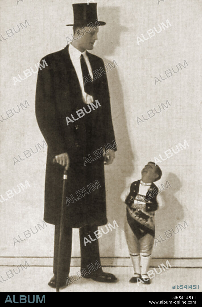 A photograph of Albert Johan Kramer, a giant, and Fred Aslett, a dwarf. Kramer is 8 ft 9 3/4 inches; Aslett is 2ft 4 inches. Gigantism is a rare disorder resulting from increased levels of growth hormone before the fusion of the growth plate, which usually occurs at some point soon after puberty. This increase is most often due to abnormal tumor growths on the pituitary gland. Dwarfism can result from many medical conditions, each with its own separate symptoms and causes. Extreme shortness in humans with proportional body parts usually has a hormonal cause, such as growth-hormone deficiency, once called pituitary dwarfism. Two disorders, achondroplasia and growth hormone deficiency, are responsible for the majority of human dwarfism cases.