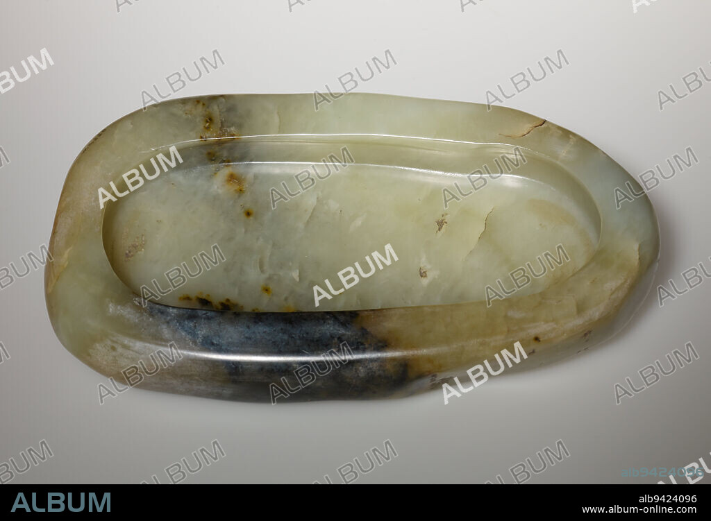 Brush Washer, 18th-19th century, 4 3/4 x 9 in. (12.07 x 22.86 cm), Nephrite (jade), China, 18th-19th century, These two bowls would have been used on the scholar's desk as brush washers. The larger one retains the original surface of the boulder from which it was carved. This respect for the natural shapes and muted colors of nephrite perfectly reflected Ming scholarly taste. Used in China since prehistoric times, jade held ancient connotations for the literati. The scholar's preference for natural form and understated color stands in marked contrast to the aristocracy's desire for the larger, more intricatedly carved and brightly colored jades. The smaller brush washer has a four character mark that reads, 'appreciated by Qianlong,' who ruled from 1736-1795.