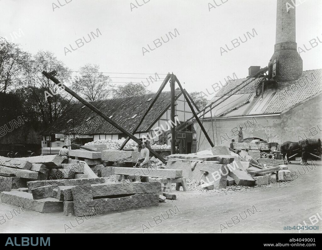 Stonecutters working with granite, Landskrona, Sweden, 1930. In the background a limeworks can be seen. From the Landskrona Museum Collection.
