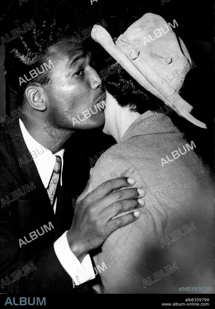 Accolade For Robinson -- World middleweight boxing champion Sugar Ray Robinson receives the traditional Gallic kiss from Madame Auriol, wife of the French president, at a Paris ceremony May 16, at which Robinson handed Madame Auriol a cheque for $10,000 from the American Damon Runyon Fund for cancer research in France. June 1, 1951. (Photo by Associated Press Photo).