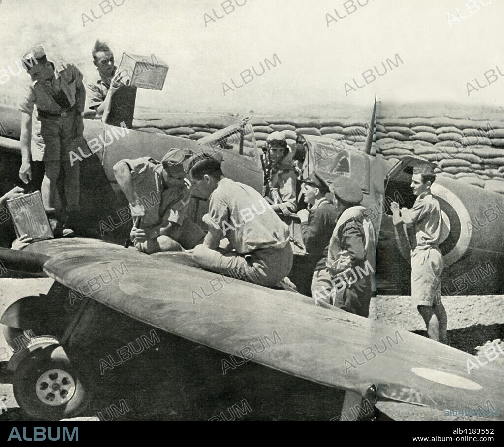 Refuelling and re-arming Spitfire fighters, Malta, World War II, 1942 (1944). 'Each to his Station. - While the pilot waits, soldiers and airmen refuel and reammunition his Spitfire in its pen'. From "The Air Battle of Malta". [His Majesty's Stationery Office, London, 1944].