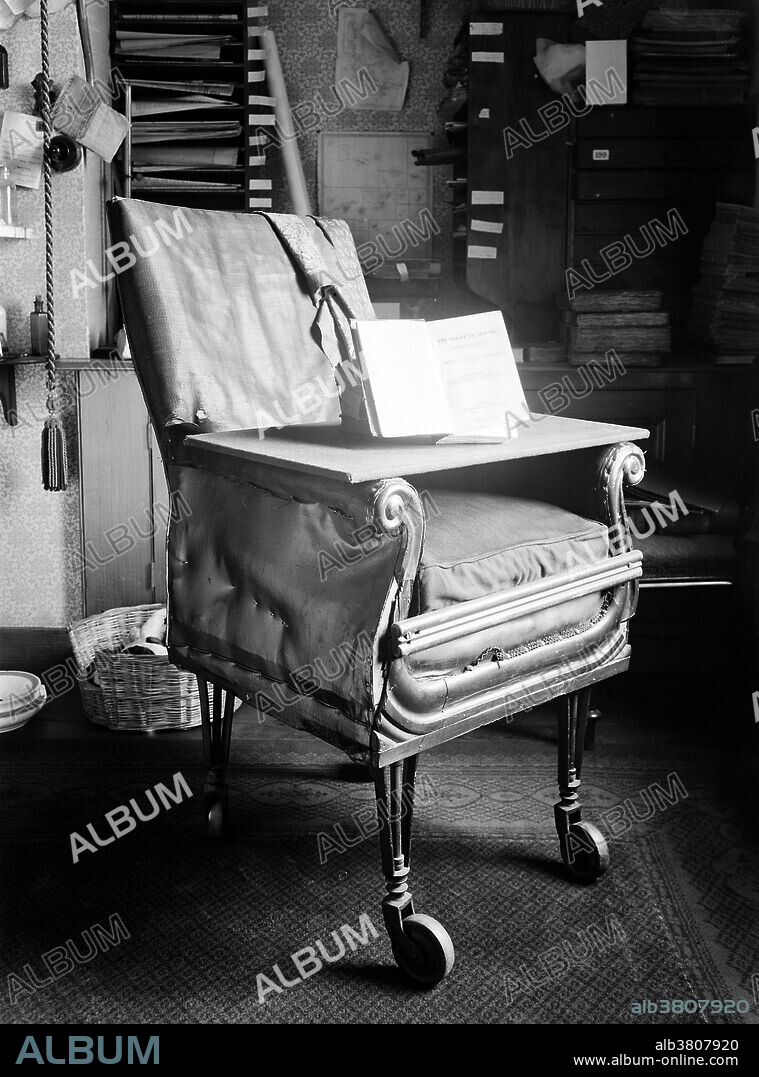 A first edition of Charles Darwin's "Origin of Species" is displayed on his writing board, which rests on a wheeled armchair of his own design in his study at Down House, Kent. The Darwin family moved from their cramped house in London to Down House in 1842. Charles Darwin worked here for 40 years till his death on April 19, 1882. Photograph circa 1932.