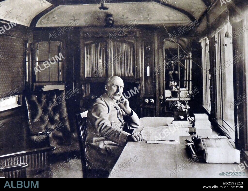 World War 1 - French General Philippe Petain in his private carriage during his military tour to Verdun in August 1916.  Petain toured the front by rail, meeting with senior officers.  Note the field telephone which appears on his desk enabling him to keep in touch with military high command..