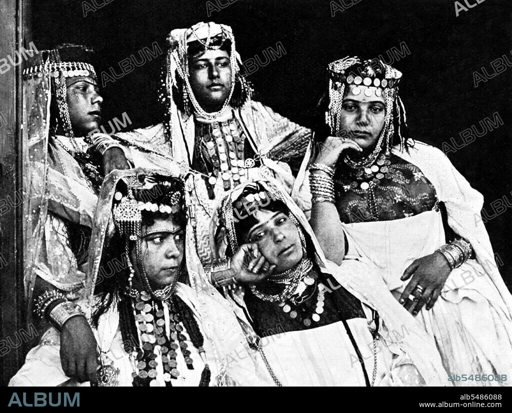 Berbers are the indigenous peoples of North Africa west of the Nile Valley. They are discontinuously distributed from the Atlantic to the Siwa Oasis, in Egypt, and from the Mediterranean to the Niger River. Historically they spoke various Berber languages, which together form a branch of the Afro-Asiatic language family. Photography probably by Lehnert & Landrock: Rudolf Franz Lehnert (Czech) and Ernst Heinrich Landrock (German) had a photographic company based in Tunis, Cairo and Leipzig before World War II. They specialised in somewhat risque Orinetalist images of young Arab and Bedouin women, often dancers.
