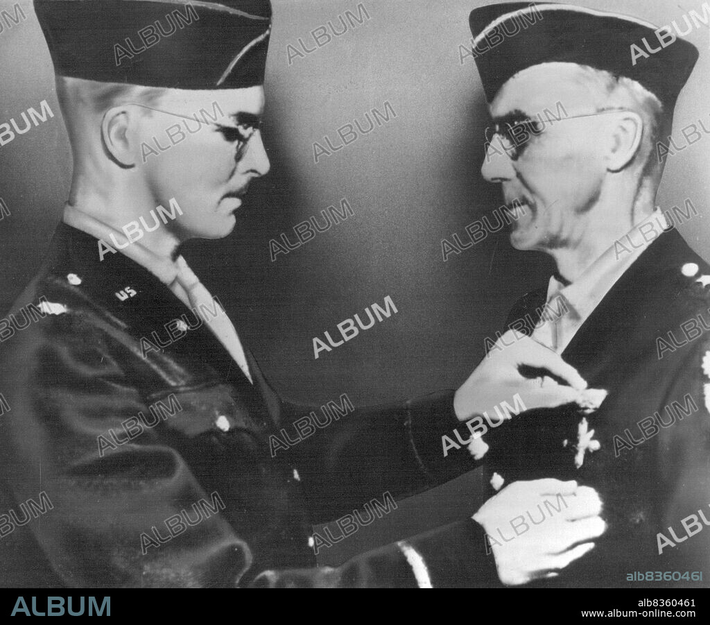 General Stilwell Decorated By His Son -- Lt. Col. Joseph W. Stilwell, Jr., of the U.S. Army, pins the Distinguished Service Cross on the Winter field jacket of his father, Lt. Gen. Joseph W. Stilwell, in a surprise ceremony "somewhere in China". General Stilwell, commander of U.S. forces in China, India and Burma, has boon in the Far East for 11 years. He was a U.S. military attach in China for many years before becoming Chief of Staff for Generalissimo Chiang Kai-shek and commander of the American Army units. May 10, 1943. (Photo by U.S. Office of War Information Picture).