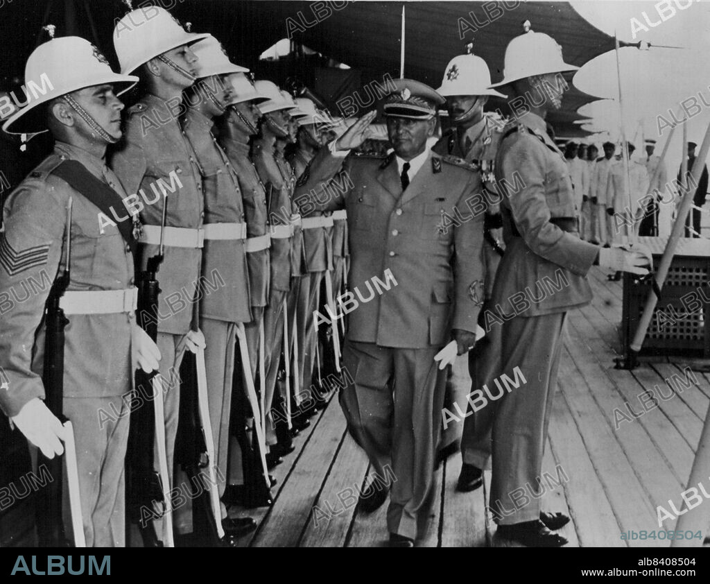 Admiral Tito Visits HMS Liverpool -- First photograph of Marshal Tito on board the HMS Liverpool at Split, Yugoslavia, his first visit to a British Warship. Marshal Tito is seen inspecting a Royal Marine Guard of Honour on board the Liverpool. September 01, 1951. (Photo by Fox Photos).