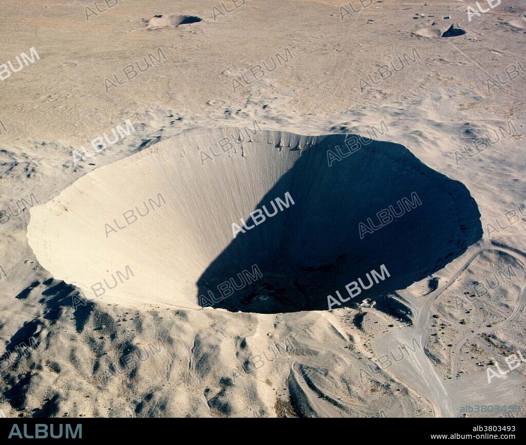 Sedan Crater is a 1,280 by 320 foot crater was created on July 6, 1962 by a 104-kiloton-of-TNT (440 TJ) nuclear explosion. The device was buried 635 feet below the desert floor in Area 10 of Yucca Flat and was the largest cratering shot in the Plowshare Program. The explosion created fallout that affected more US residents than any other nuclear test, exposing more than 13 million people to radiation and marked the end of the program. The crater was listed on the National Register of Historic Places on March 21, 1994. The crater can be seen from earth orbit with the unaided eye. Operation Storax was a series of 47 nuclear tests conducted by the United States in 1962-1963 at the Nevada Test Site. Sedan was one of the most spectacular nuclear test ever fired in the continental United States. It was an LRL test conducted under the auspices of the Plowshare program, which was an attempt to develop non-military uses for nuclear explosives. The purpose of Sedan was to investigate the potential of "clean" thermonuclear devices for producing large craters cheaply. Look to the size of the roads in the bottom-right of the picture, and the observation deck at the lower-right edge of the crater, for a sense of scale. AKA Project Plowshare was the overall United States term for the development of techniques to use nuclear explosives for peaceful construction purposes.