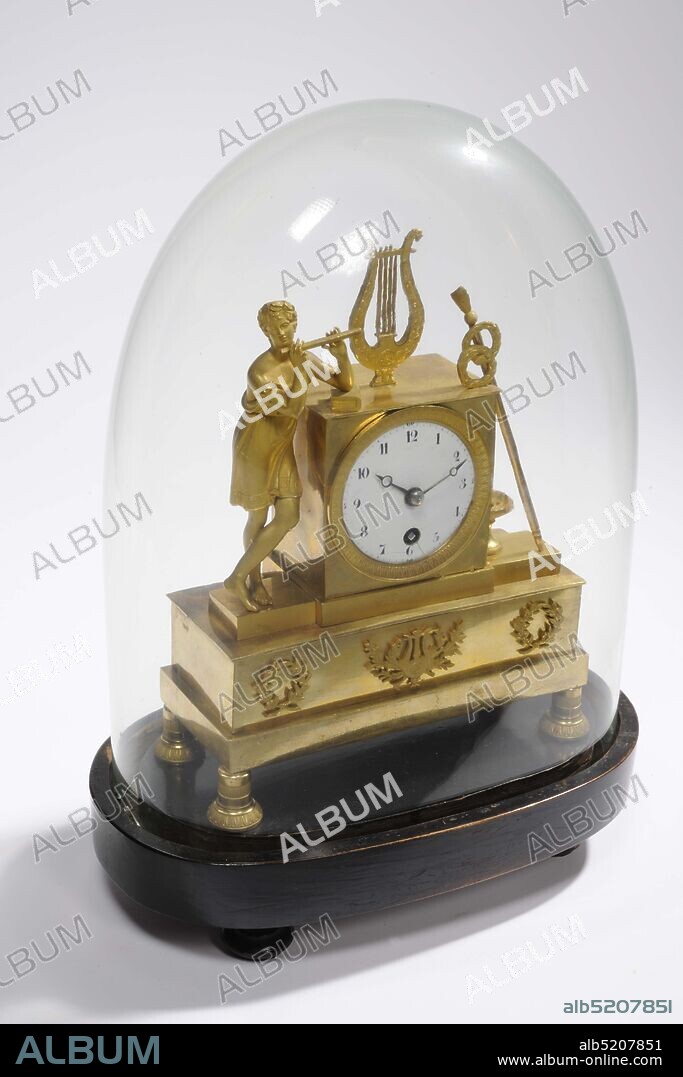 mantel clock, Anonymous, approx. 1800, glass, wood, enamel, brass, Total: 36 x 26 x 15.8cm 360 x 260 x 158mm, Bell: 30.8 x 23.5 x 13.8cm 308 x 235 x 138mm, Base: 6 x 26 x 15.8cm 60 x 260 x 158mm, flute, music making, lyre, Empire fire-gilded brass mantel clock under glass bell jar. On the right side of the clock a boy playing a flute in a short tunic leans, on top of the clock a four-stringed lyre, on the left a long staff with two wreaths and a lion's head with a bowl underneath. The clock and figures are on a beam with three wreaths on the front, the middle of which contains a harp. The whole stands on four bell-shaped legs with a stripe pattern. The dial is enamelled in white with black numbers. The glass dome has an oval shape at the bottom and a round top. A piece is missing along the edge. The mantel clock stands on a wooden, brown-painted base with a smooth, oval shape with a deep groove at the top along the edge where the glass bell falls. The foot stands on four baluster-shaped legs with a turned edge halfway, 1945.