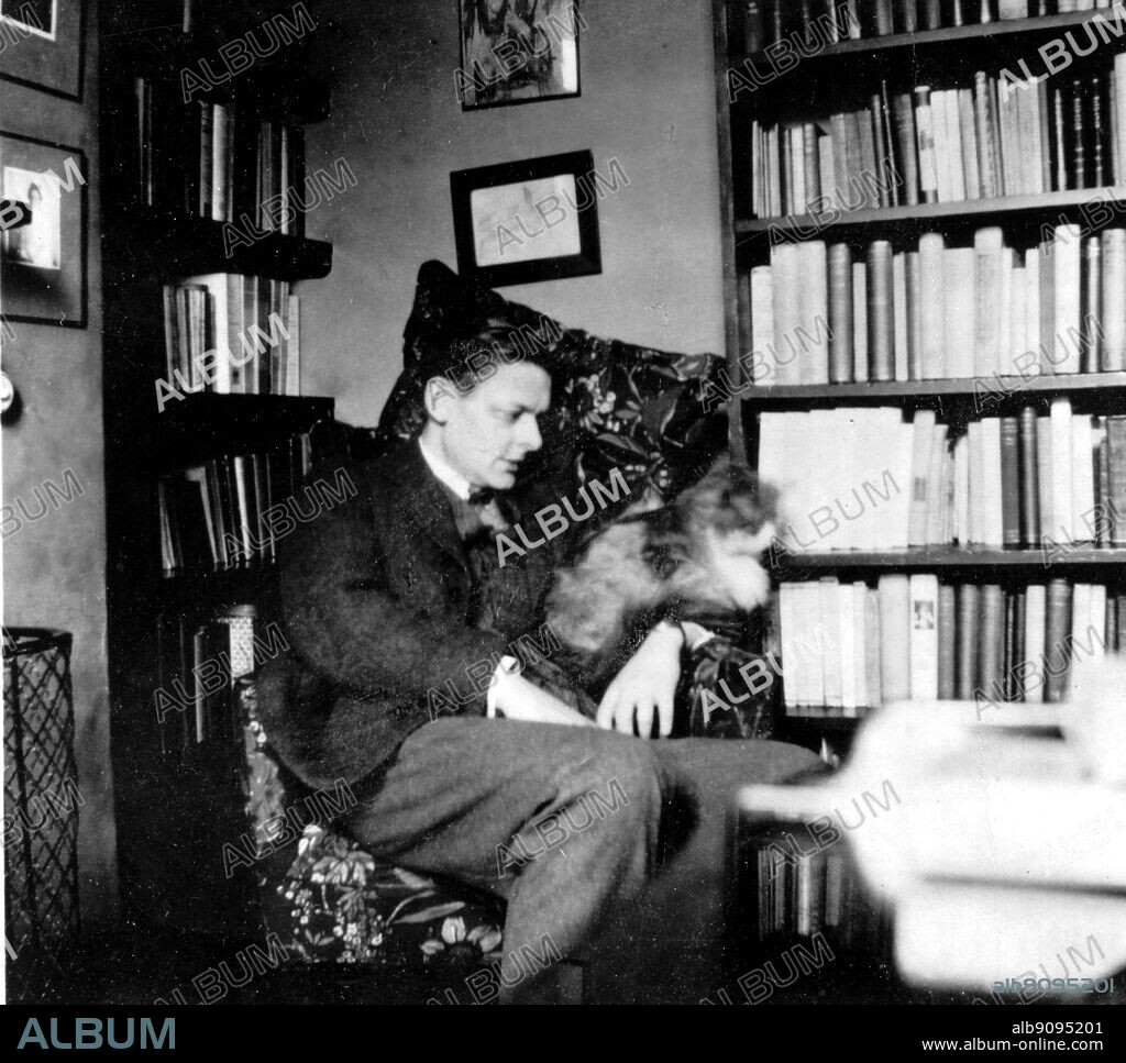 Thomas Stearns Eliot 1888-1965 57 at Chester Terrace with George the cat in his study 1928.