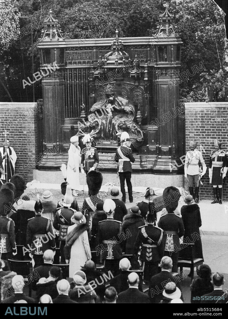 The King Unveils Memorial To His Mother Queen Alexandra, The Rose Queen - The King and Queen by the memorial after the unveiling ceremony.To-day, the 21st anniversary of Rose day- The day on which Queen Alexandra of beloved memory used to drive round London bowered with wild roses collecting money for her favourite work of beneficence - was chosen by the king for the unveiling of the memorial to the late members of the royal family, were present at the ceremony. The memorial stands on the edge of the garden of Marlborough house (London) facing Friary court, St. James palace, and the subject of the memorial is 'Faith, Hope and Charity,' sculptured by Mr. Alfred Gilbert. June 8, 1932. (Photo by The Topical Press Agency Ltd.).