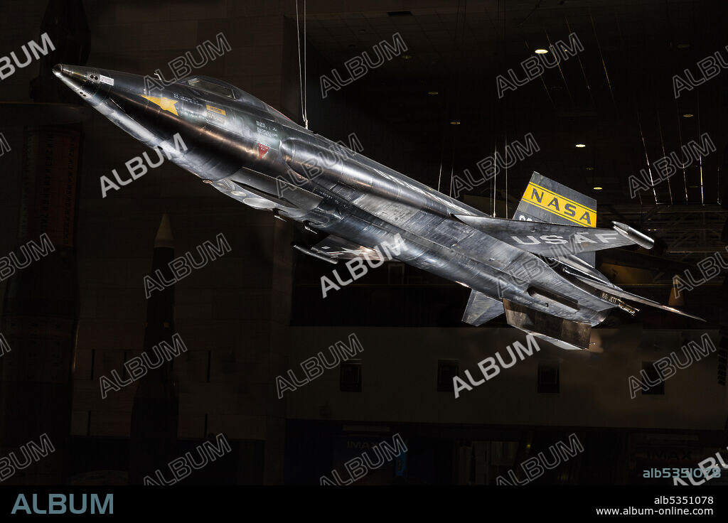 NORTH AMERICAN AVIATION INC.. World's Fastest Piloted Aircraft. Piloted by Neil Armstrong. Bridged the gap between human flight in the atmosphere and spaceflight. North American X-15, rocket powered experimental aircraft; black titanium skin with wedge shaped horizontal stablizer; yellow stripe NASA inisignia on tail with stars and red bars United States national insignia on wings; white letter text "U.S. AIR FORCE" on the sides of the fuselage.