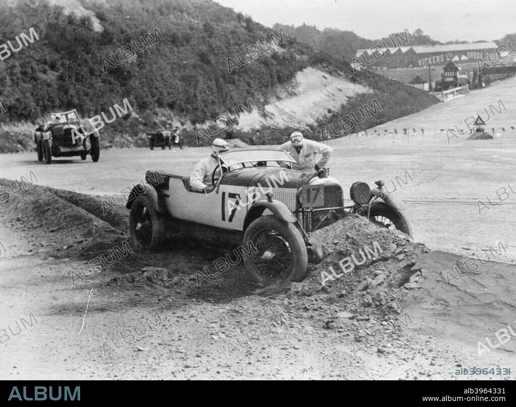 1929 Lagonda 2 litre, Brooklands, Surrey, (1930s?).The driver and co-driver of a Lagonda consider their options after running off the track into soft ground.