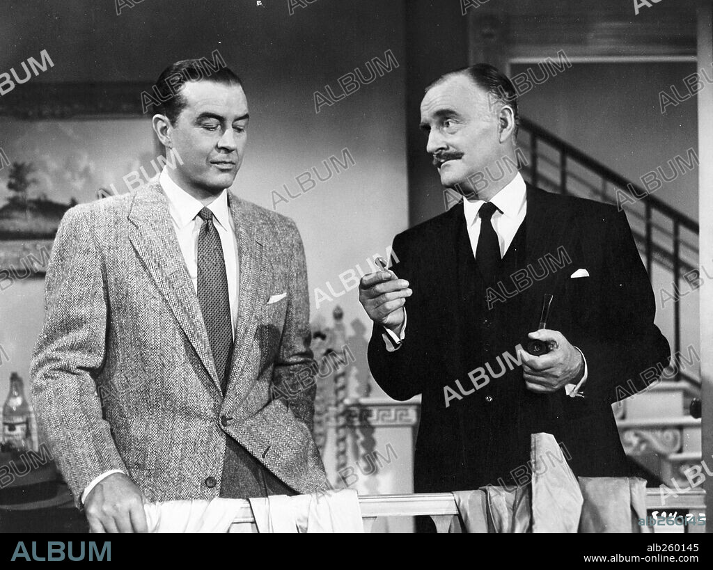 JOHN WILLIAMS and RAY MILLAND in DIAL M FOR MURDER, 1954, directed by ALFRED HITCHCOCK. Copyright WARNER BROS.